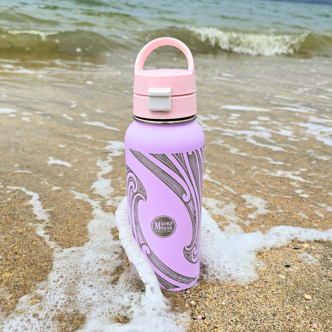 purple water bottle with a design on a beach with waves.